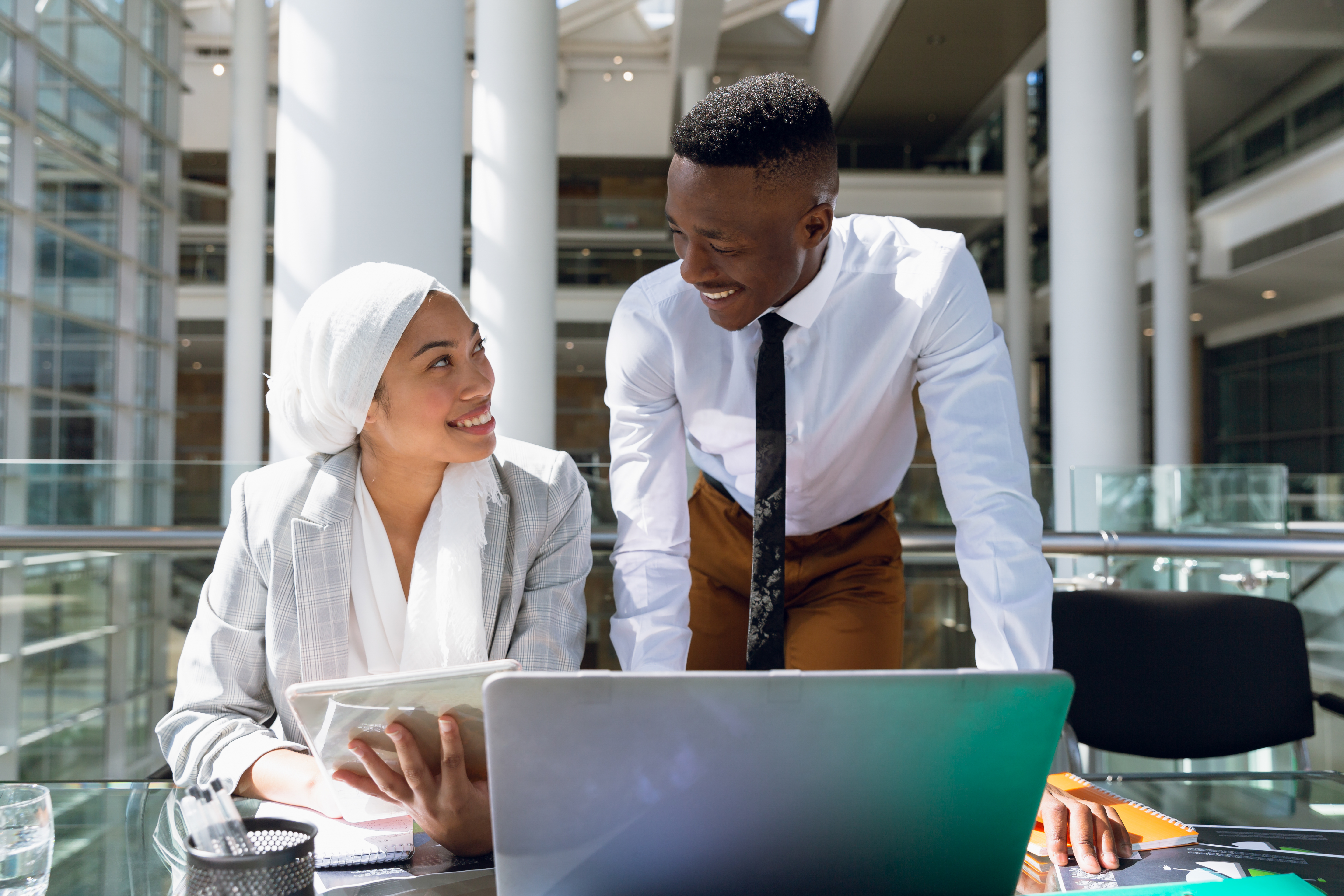 Colleagues collaborating at a laptop