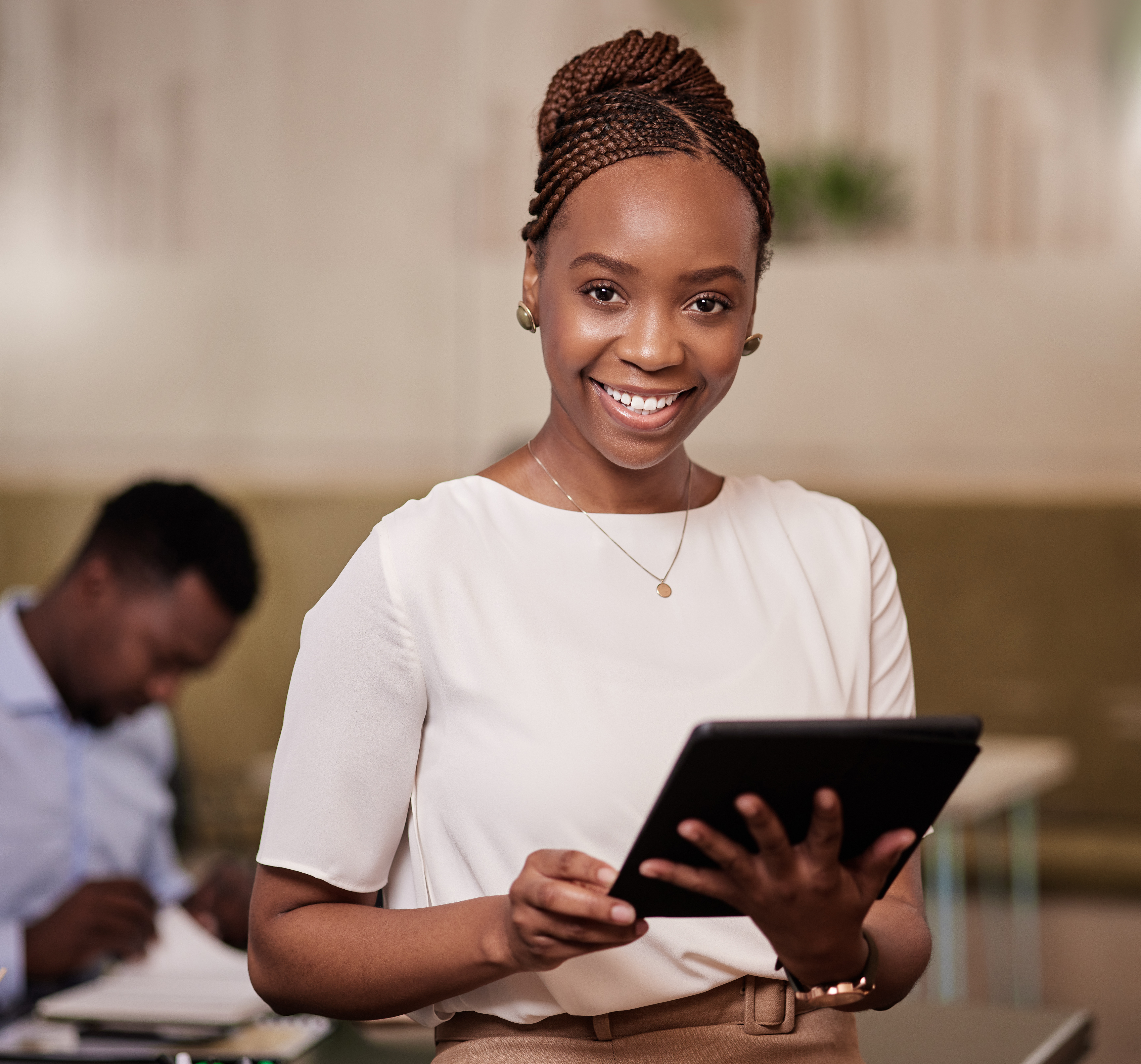 Smiling professional holding a tablet